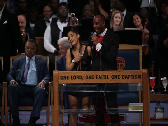 Bishop Charles H. Ellis III jokes with Ariana Grande after she performs a musical tribute during the funeral for the late Aretha Franklin at Greater Grace Temple in Detroit on Friday, Aug. 31, 2018.