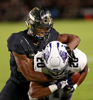 Navon Mosley of Purdue tackles John Moten IV of Northwestern in the second quarter Thursday, August 30, 2018, in West Lafayette. 