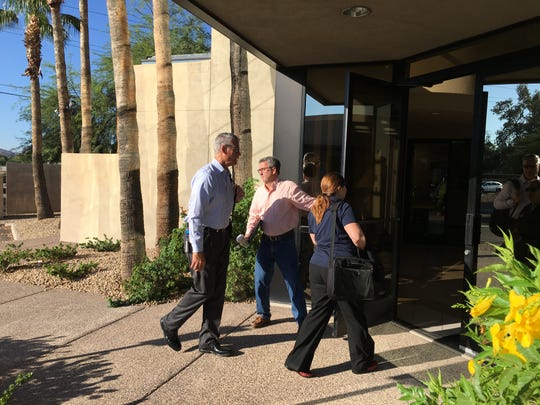 EPCOR Vice President of Operations Troy Day holds the door for colleagues, Greg Barber and Claudia Christo, as they enter the headquarters of Johnson Utilities in Phoenix on  Aug. 31, 2018. The Arizona Corporation Commission ordered EPCOR to take over as interim manager of Johnson, which has faced a variety of issues.