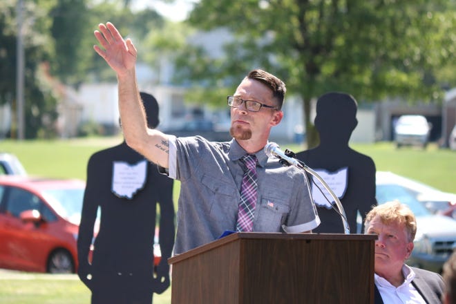 Jeffery Schill, a graduate of Ottawa County’s Drug Court, said his recovery is a product of local programs offered to help addicts receive treatment. In the background are silhouettes representing overdose deaths in Ottawa County in 2017.