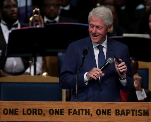 Former president Bill Clinton plays “Think” by Aretha Franklin on his phone during his speech at her funeral.