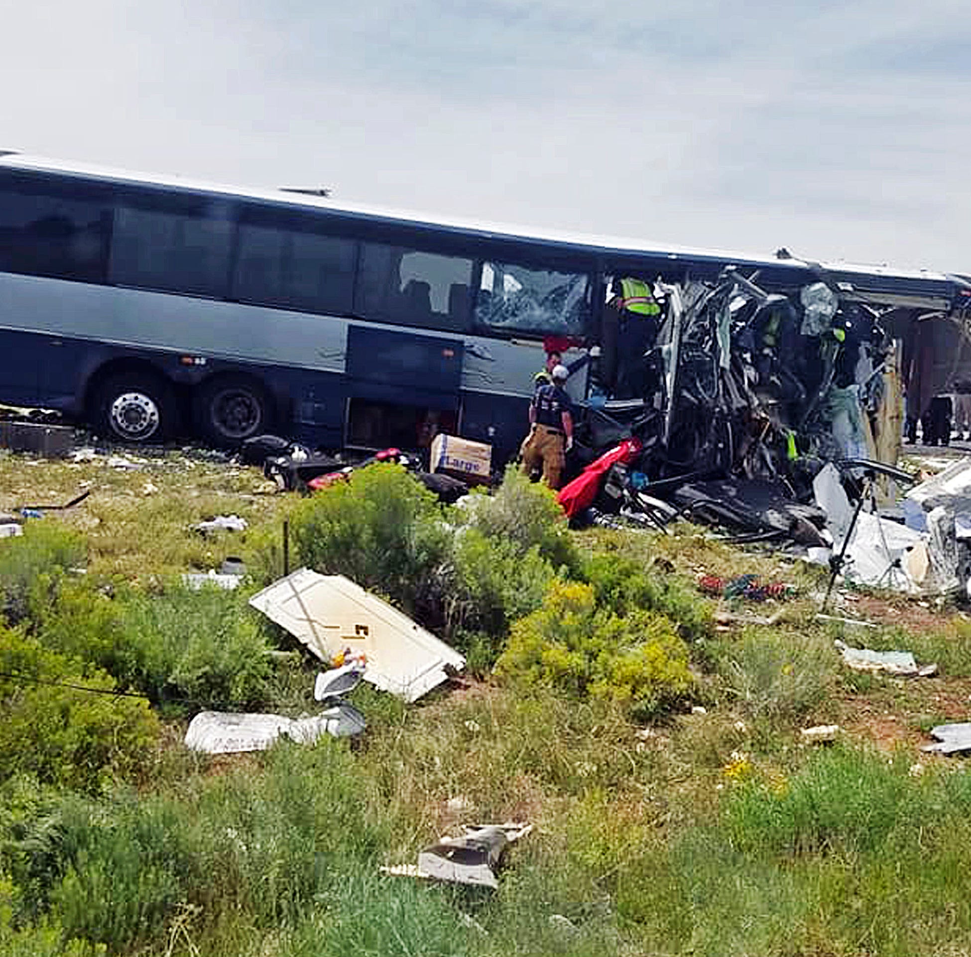 This photo provided by Chris Jones shows first responders working the scene of a collision between a Greyhound passenger bus and a semi-truck on Interstate 40 near the town of Thoreau, N.M., near the Arizona border, Thursday, Aug. 30, 2018. Multiple 
