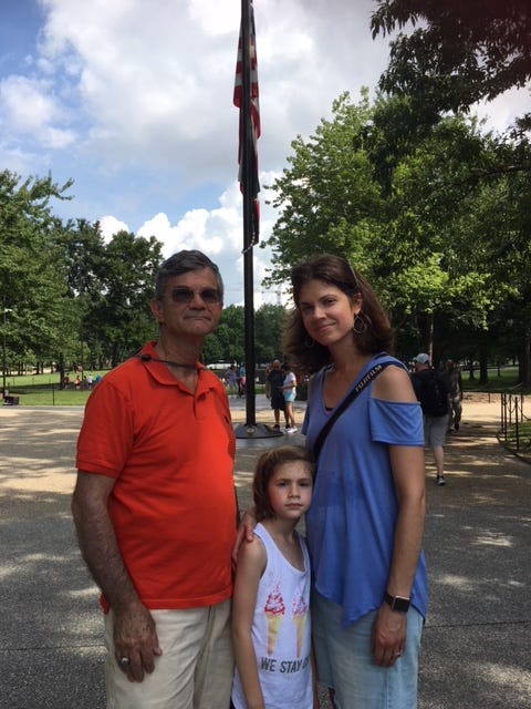 David Daks, his granddaughter, Arielle, and daughter, Danielle, stop by the Vietnam Veterans Memorial Friday.