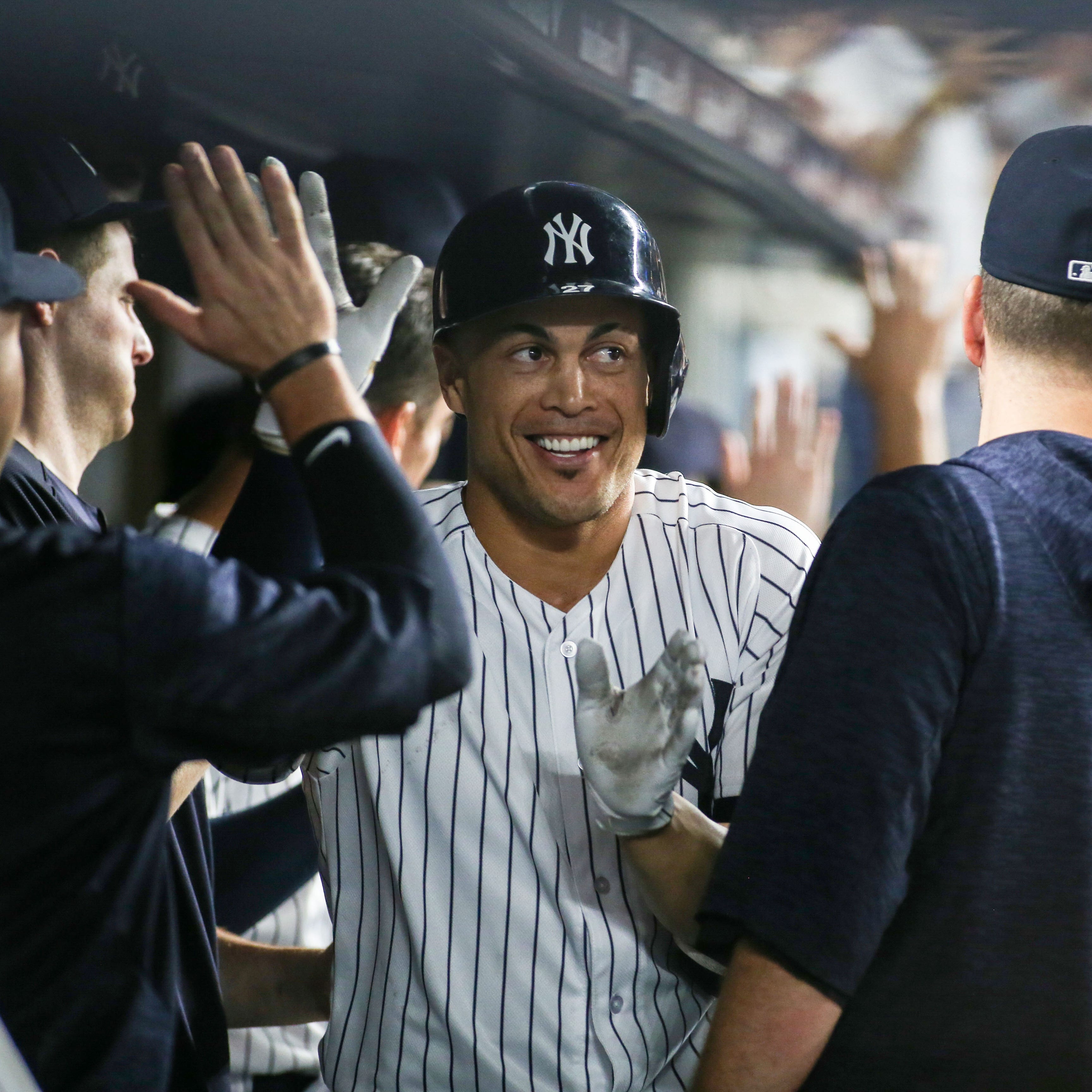 Yankees designated hitter Giancarlo Stanton celebrates with his teammates after hitting his 300th career home run in the third inning against the Detroit Tigers.