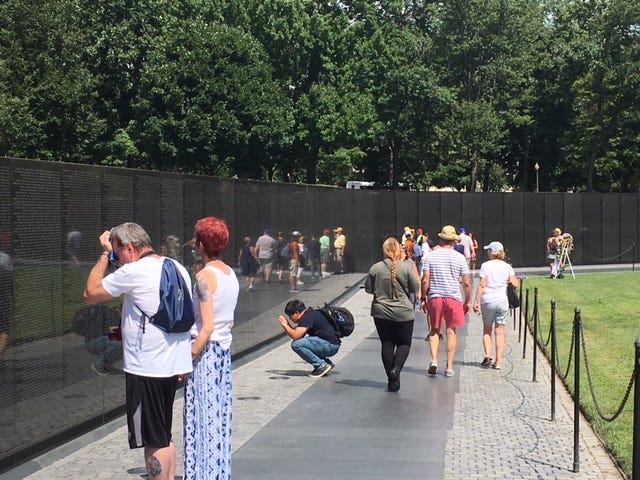 A steady stream of visitors stop by the Vietnam Veterans Memorial Friday while across town member of Congress attend a memorial ceremony for Sen. John McCain, R-Ariz, a Vietnam POW.