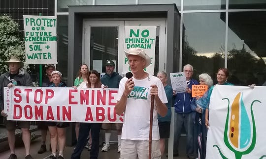 Ed Fallon, of Bold Iowa, speaks outside the Iowa Utilities Board office prior to the beginning of the First Nation-Farmer Climate Unity March. The march route will stretch nearly 100 miles across 8 days.
