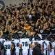 Fossil Ridge players hoist the Harmony Cup trophy to their fans after beating Fort Collins 14-6 on Friday.
