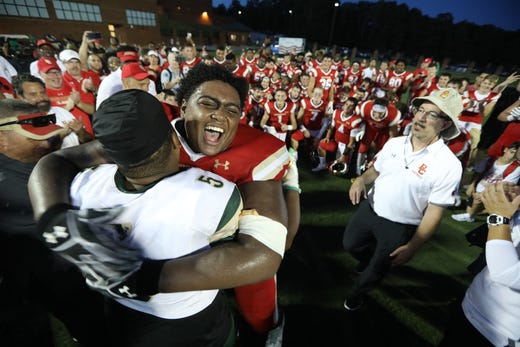 Marquis Morris, of Bergen Catholic, gives a Grayson player a big hug after he came over to congratulate the Crusaders.   Friday, August 31, 2018