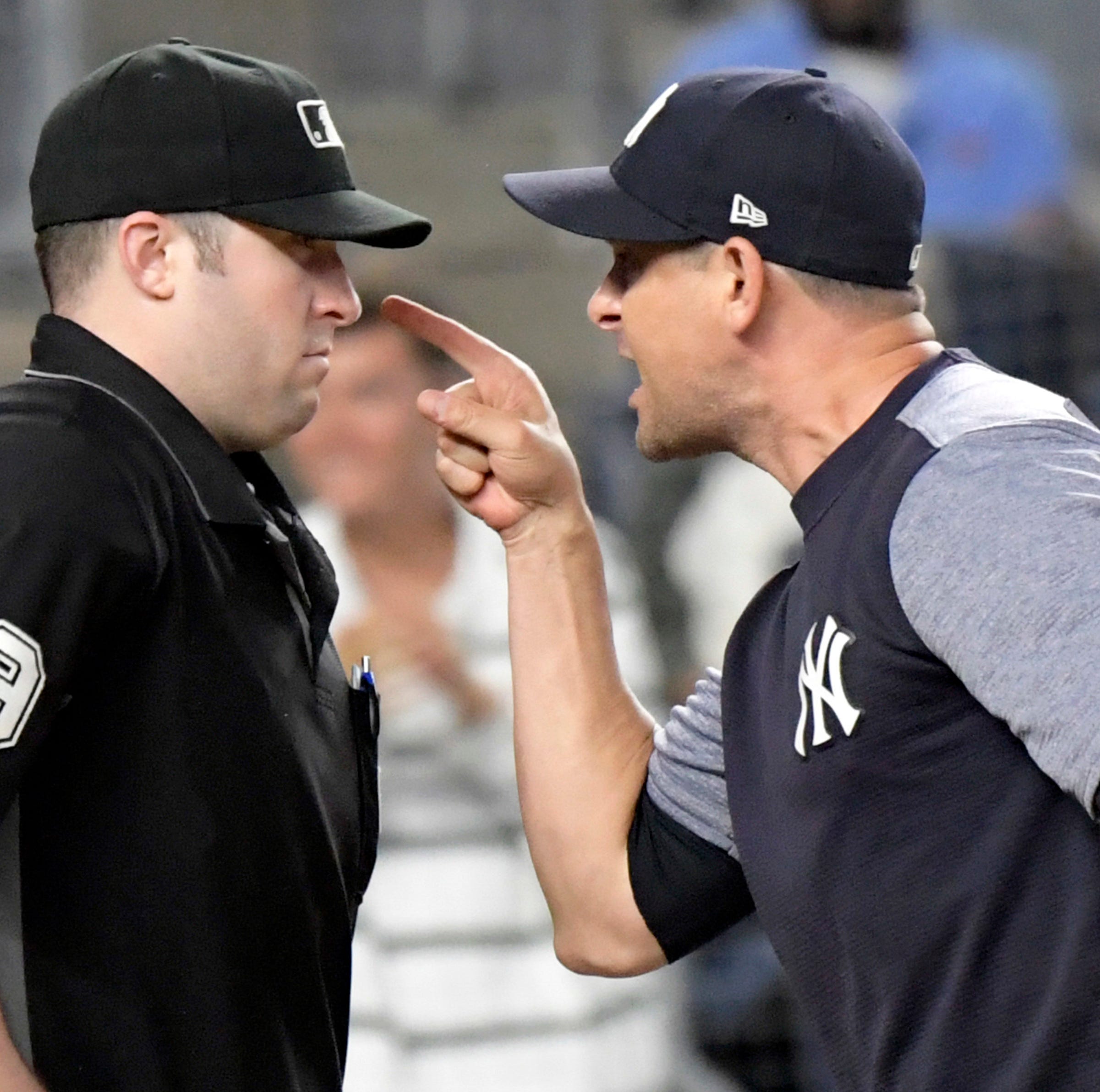 New York Yankees manager Aaron Boone, right, confronts umpire Nic Lentz (59) before being tossed from a baseball game against the Detroit Tigers during the fifth inning Friday, Aug. 31, 2018, at Yankee Stadium in New York.