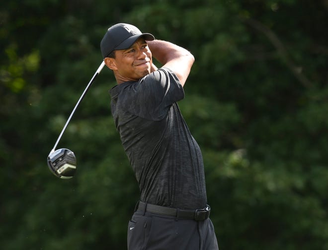 Tiger Woods hits his tee shot on the 14th hole during the first round of the Dell Technologies Championship golf tournament at TPC of Boston.