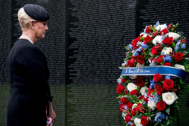 Cindy McCain, wife of, Sen. John McCain, R-Ariz., lays a wreath at the Vietnam Veterans Memorial in Washington, during a funeral procession to carry the casket of her husband from the US Capitol to National Cathedral for a Memorial Service.