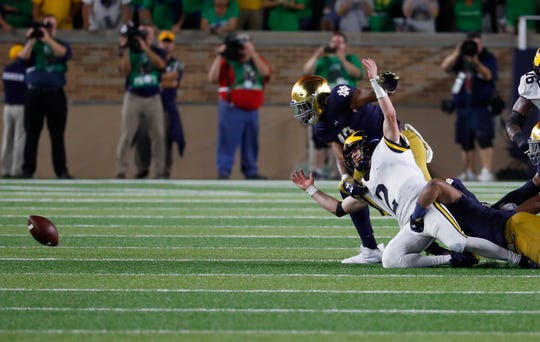 Michigan quarterback Shea Patterson fumbles the ball against Notre Dame in the fourth quarter in South Bend, Ind., Saturday, Sept. 1, 2018. Notre Dame won 24-17.
