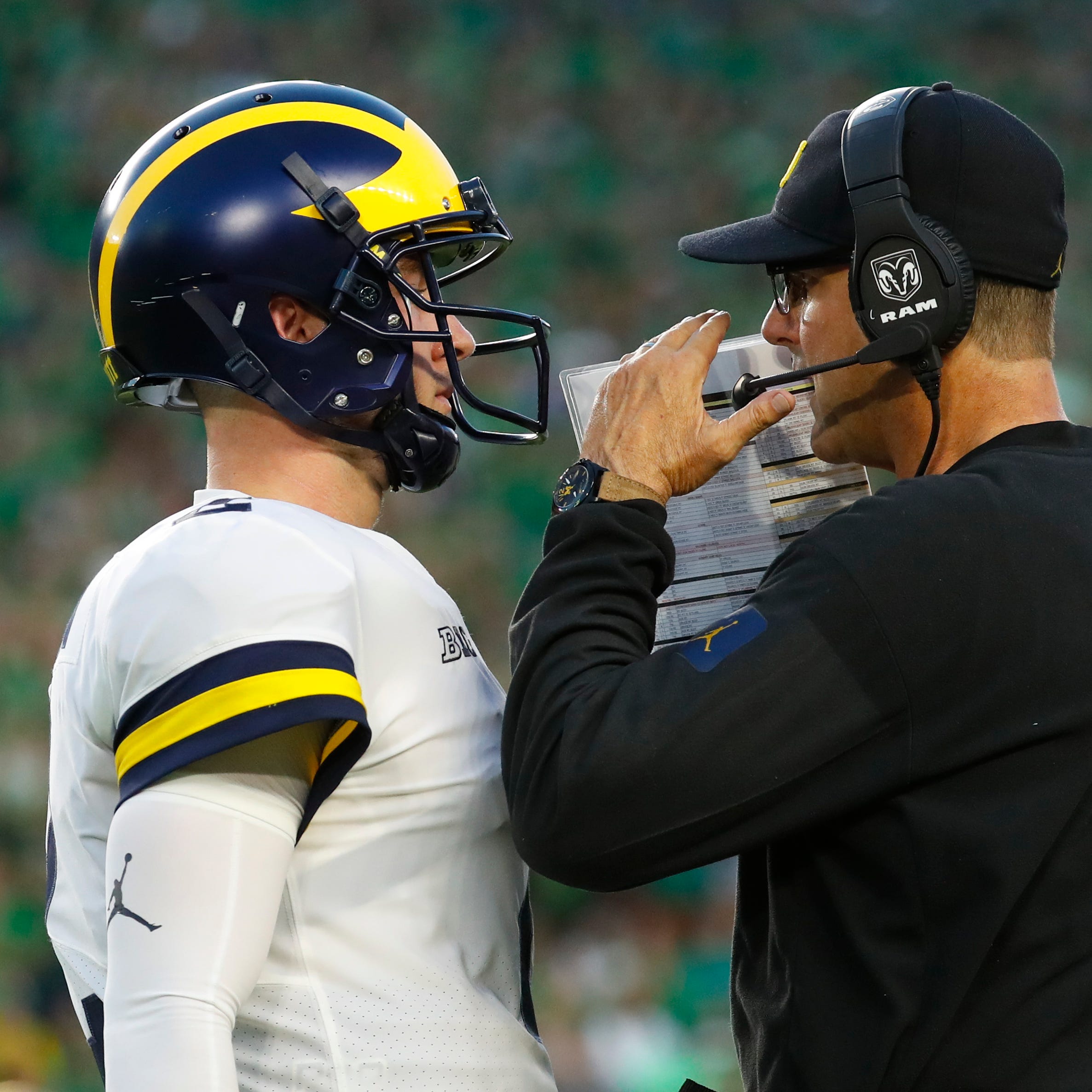 Michigan coach Jim Harbaugh talks with quarterback Shea Patterson in the first half Saturday, Sept. 1, 2018 against Notre Dame in South Bend, Ind.