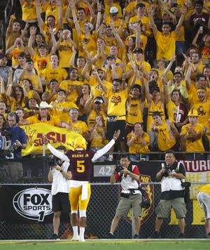 Arizona State Sun Devils quarterback Manny Wilkins (5) celebrates with the fans after ASU scored against UTSA during the second quarter at Sun Devil Stadium in Tempe, Ariz. on Sept. 1, 2018.