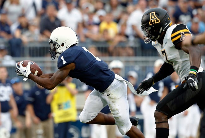 Penn State's KJ Hamler (1) makes a catch in front of Appalachian State's Josh Thomas (7) during the second half of an NCAA college football game in State College, Pa., Saturday, Sept. 1, 2018. Penn State won 45-38 in overtime. (AP Photo/Chris Knight)