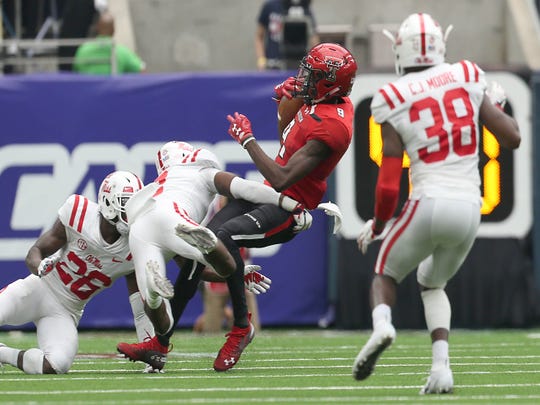 Texas Tech wide receiver T.J. Vasher is tackled by Mississippi defensive back Jaylon Jones.