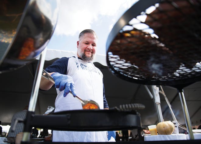 Jason Hollingsworth with Rare Roots Hospitality grills up meat and peppers during Euphoria's Feast by the Field on Saturday, September 23, 2017.