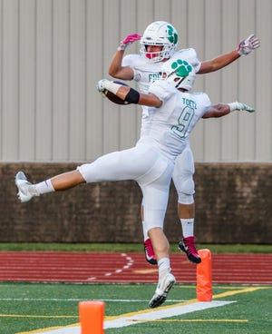 Greendale running back Paul Toetz (9) celebrates his touchdown with teammate J.R. Muth during the game at Pewaukee on Friday, August 31, 2018.