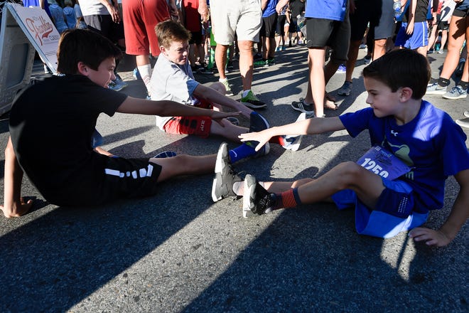 Carter Greene, Derby Jones and Charlie Greene stretch before the 40th Franklin Classic 5k Race. Williamson County ranks as the healthiest — and wealthiest — county in the state.