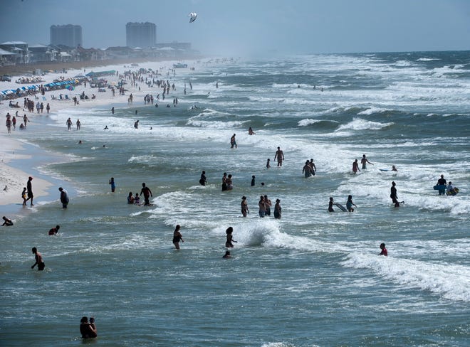 Visitors and locals enjoy the sun, sand, and surf at Pensacola Beach this Labor Day, Sept. 3, 2018. 