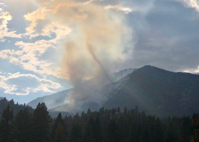 Smoke from the Slide Fire rises over Washoe Valley  on Sunday, Sept. 2, 2018.  Search and rescue crews were working to locate a downed aircraft reported to have started the fire.