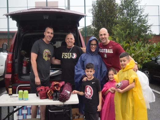 A family tailgates during the Florida State versus Virginia Tech game on Monday.