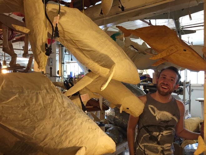 Kristian Brevik stands among his whale lanterns in his studio at Pine and Howard streets in Burlington.