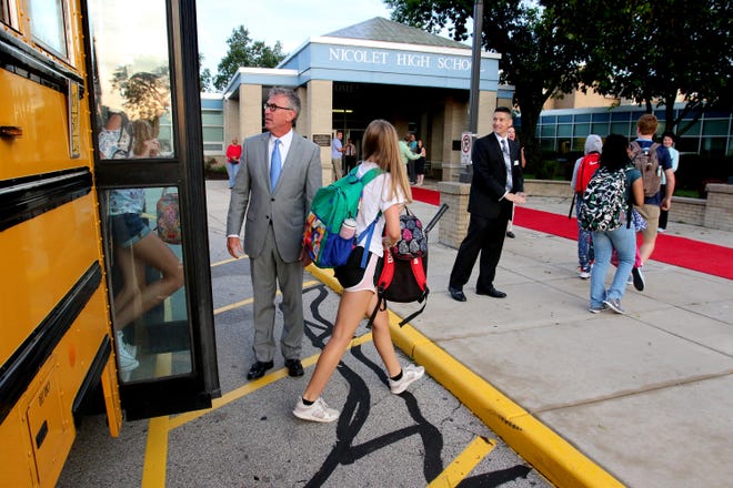 Nicolet School District Superintendent Robert Kobylski and High School Principal Greg Kabara greet students as they arrive by bus and head for the red carpet for the first day of the 2018-19 school year on Sept. 4. Kobylski will be leaving the district June 1 to take a similar role in Davenport, Iowa. Kabara will become superintendent of just Nicolet High School July 1.