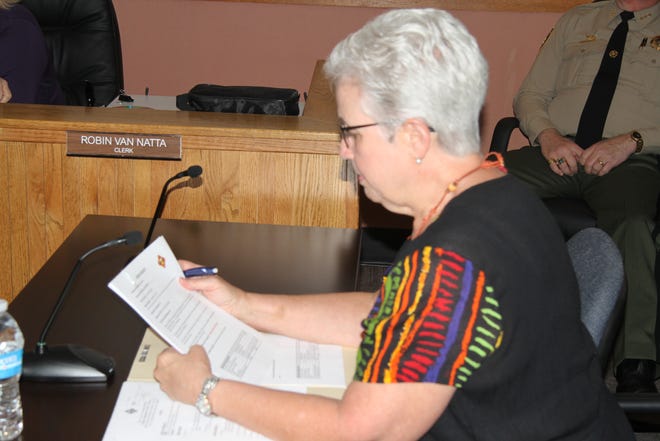 Eddy County Assessor Gemma Ferguson looks over paperwork for a proposed 15 percent pay raise for elected officials during Tuesday's Eddy County Commission meeting.