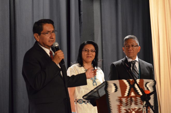 Navajo Nation presidential candidate Jonathan Nez, left, talks about running mate Myron Lizer, third from left. Lizer was joined by his wife, Dottie Lizer, second from left, at the announcement on Tuesday in Window Rock, Arizona.