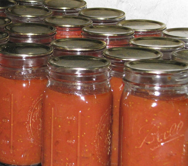 A pot of tomatoes, cooked down, blended, and then canned, brings some summer-y flavor to the dead of winter.