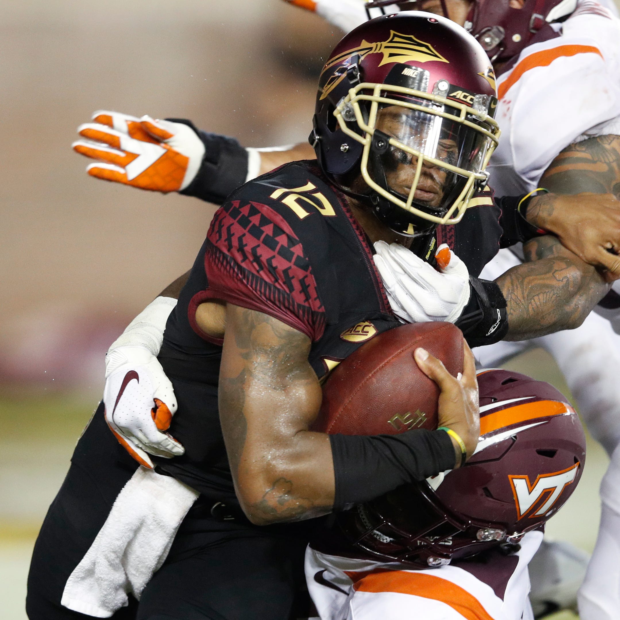 Florida State's Deondre Francois gets sacked by Virginia Tech's Trevon Hill in the second quarter of the game at Doak Campbell Stadium.