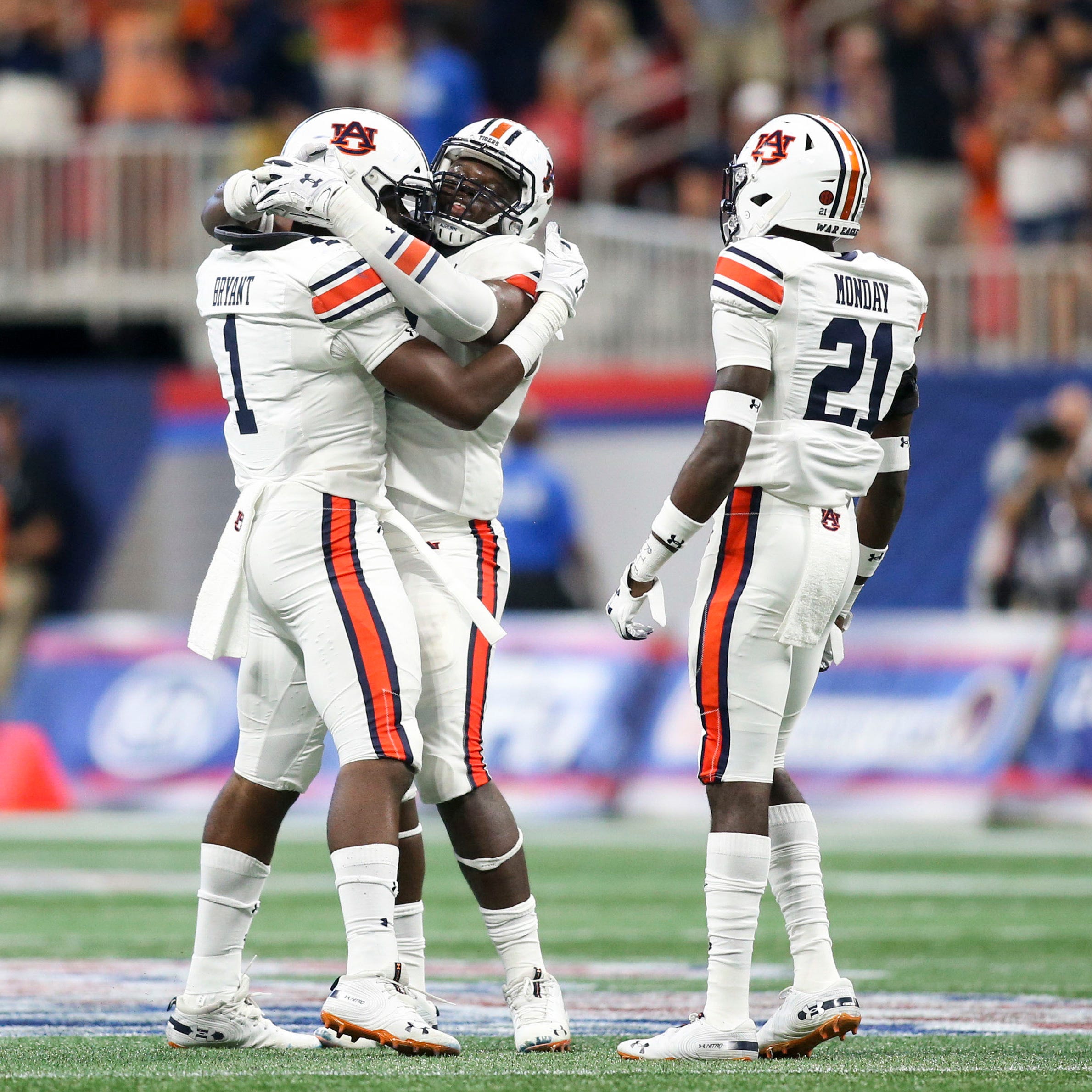 Auburn players celebrate after a sack during the fourth quarter against Washington.