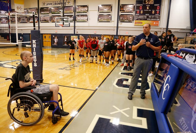 Central Catholic head coach Brad McCarter says a few words on behalf of Tyler Trent, left, before the Knights and Lafayette Jeff meet up to Spike Out Cancer Tuesday, September 4, 2018, in Lafayette. Trent is a Purdue sophomore battling cancer. CC defeated Jeff 25-14, 25-17, 25-13.