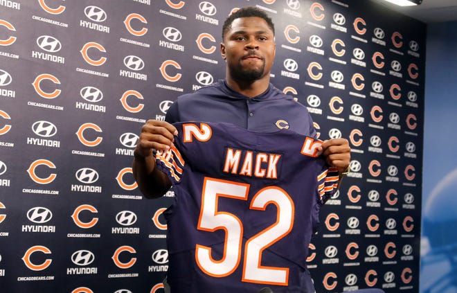 Newly acquired Chicago Bears player Khalil Mack displays his jersey after speaking to the media  during a news conference Sunday, Sept. 2, 2018, at Halas Hall in Lake Forest, Ill.