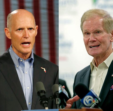 Florida Republican Gov. Rick Scott, left, is...