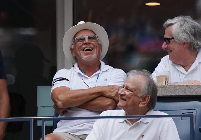 Singer Jimmy Buffett laughs as he watches Rafael Nadal against Nikoloz Basilashvili.