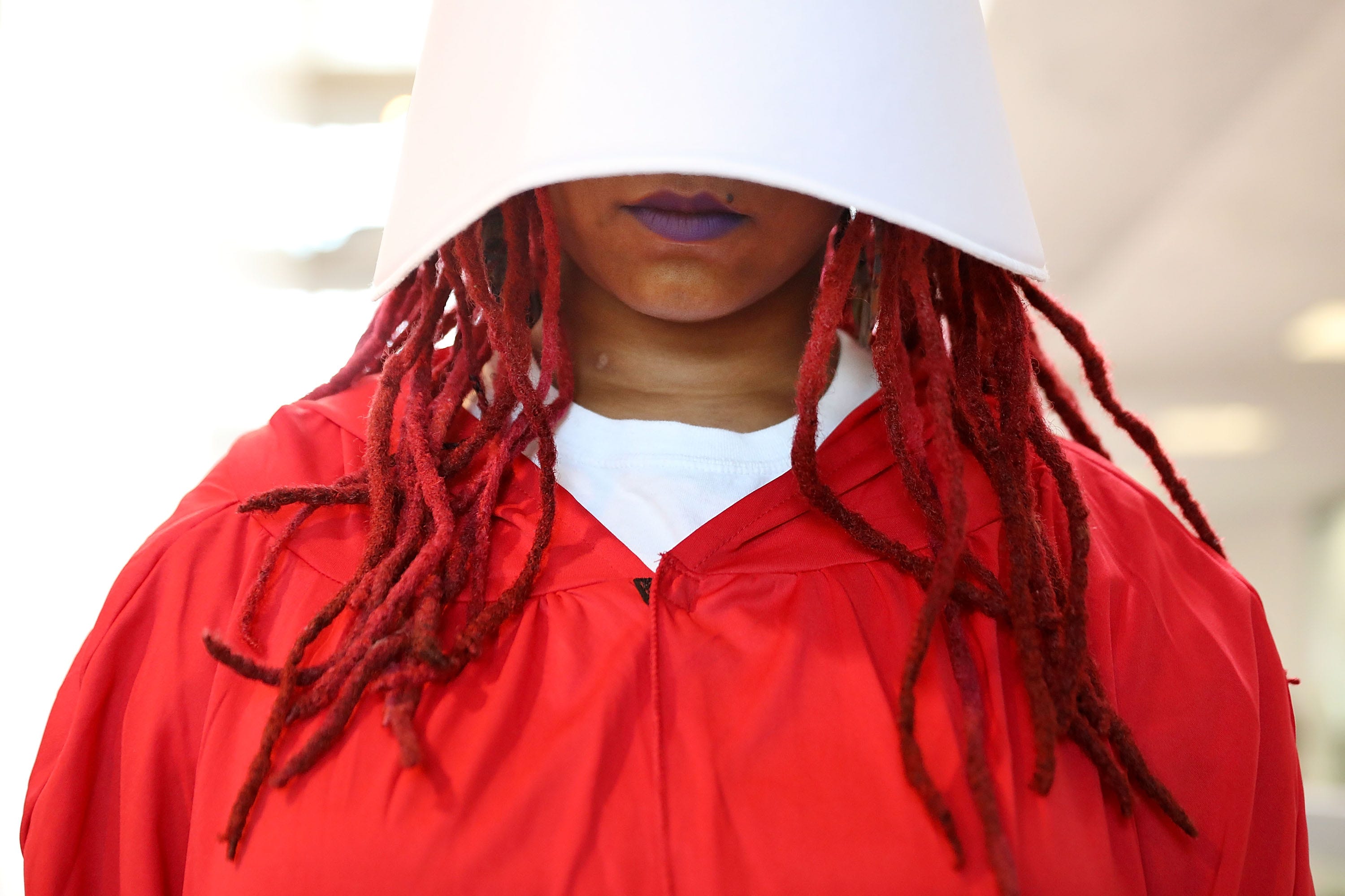 WASHINGTON, DC - SEPTEMBER 05:  A demostrator dressed as a character from The Handmaid's Tale protests outside the hearing room where Supreme Court nominee Judge Brett Kavanaugh was to testify before the Senate Judiciary Committee during his Supreme Court confirmation hearing in the Hart Senate Office Building on Capitol Hill September 5, 2018 in Washington, DC. Kavanaugh was nominated by President Donald Trump to fill the vacancy on the court left by retiring Associate Justice Anthony Kennedy.  (Photo by Chip Somodevilla/Getty Images) ORG XMIT: 775208795 ORIG FILE ID: 1027070514
