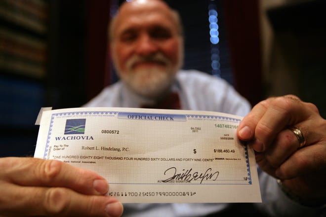 Phony check scams have been tricking consumers for years, including lawyers. The Better Business Bureau issued a warning in September about how fake checks are on the upswing now. File photo: Robert Hindelang, Grosse Pointe Farms lawyer, nearly got conned out of $188,460 back in 2009 when a man purporting to represent an international textile company arranged for him to receive this counterfeit check. Before wiring the money to the man who contacted him, Hindelang called the bank whose name was listed on the check and discovered it was counterfeit.
