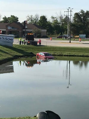 A car sits in a retention pond along the 2300 block of West Ryan Road in Oak Creek on Aug. 31.