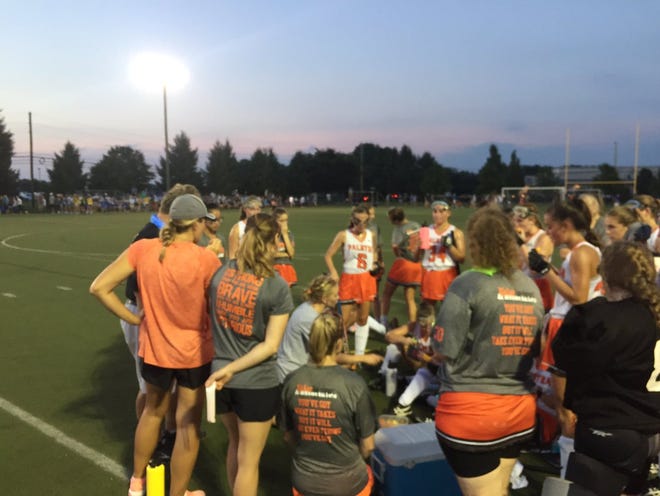 The Palmyra field hockey team discusses strategy at halftime of Wednesday's 0-0 tie with arch rival Lower Dauphin.