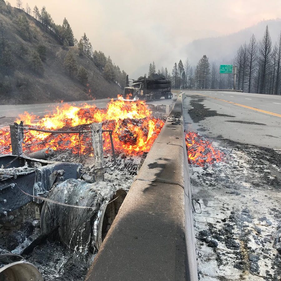 A couple trucks that burned up in the Delta Fire remained burning Wednesday evening on Interstate 5 north of Redding.