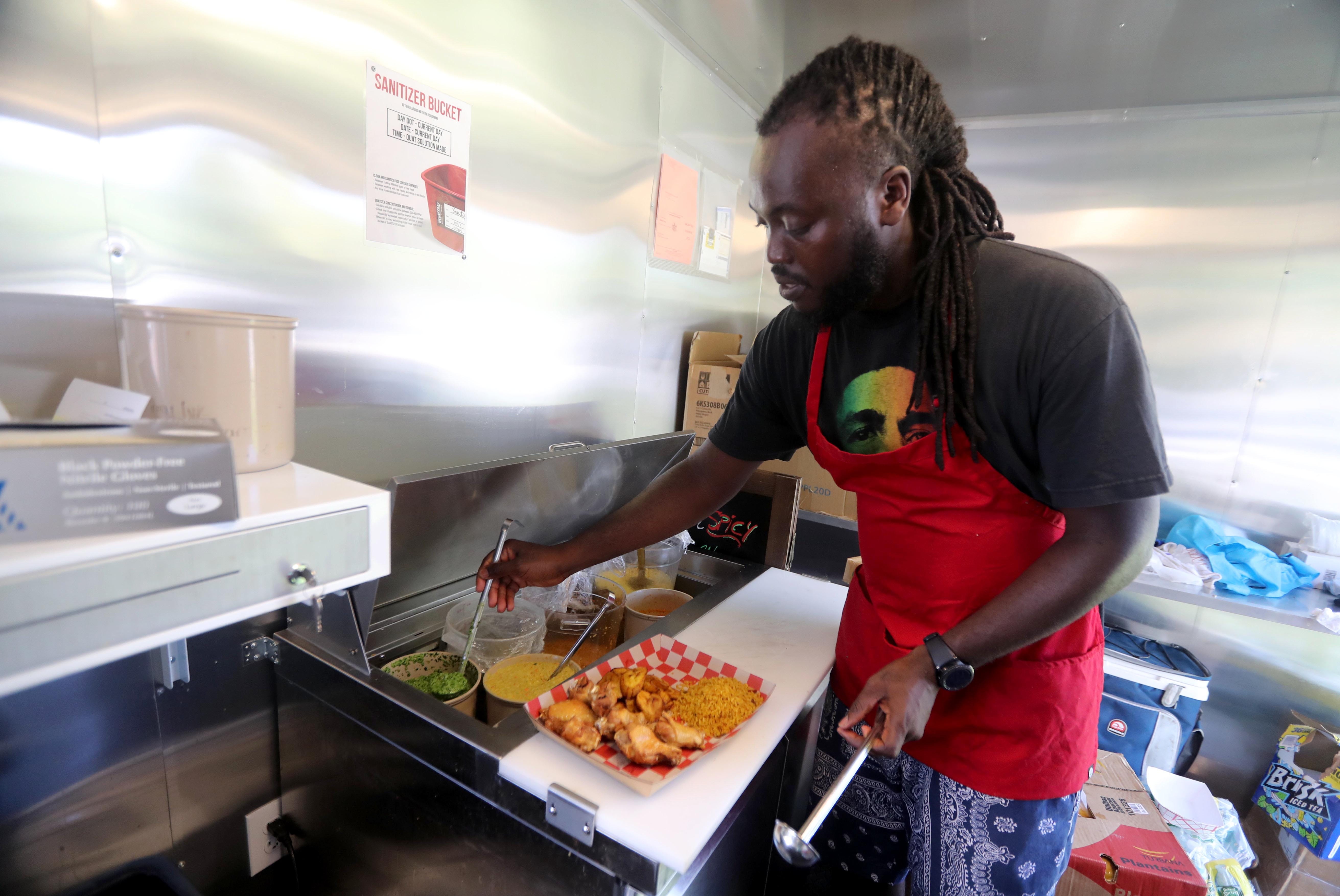 Chef Lawrence Ofori, owner of Spicy, a food truck located outside the Jefferson Valley Mall in Yorktown Heights, specializes in rices, chicken wings and different types of fish, all prepared with his homemade sauces.