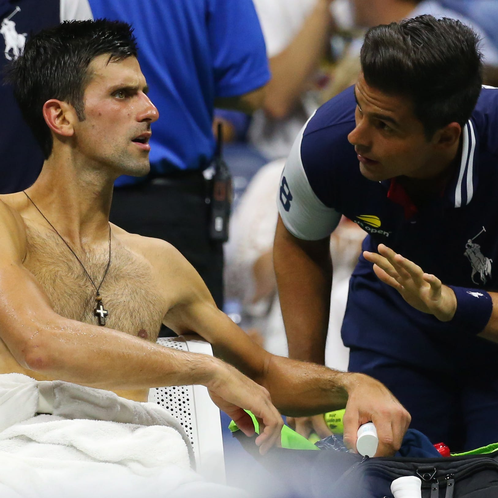 Novak Djokovic talks to a ball boy during a break in the second set.
