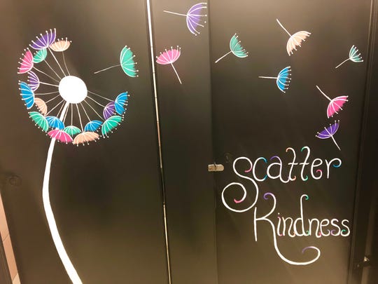Teachers paint positive messages on bathroom stalls