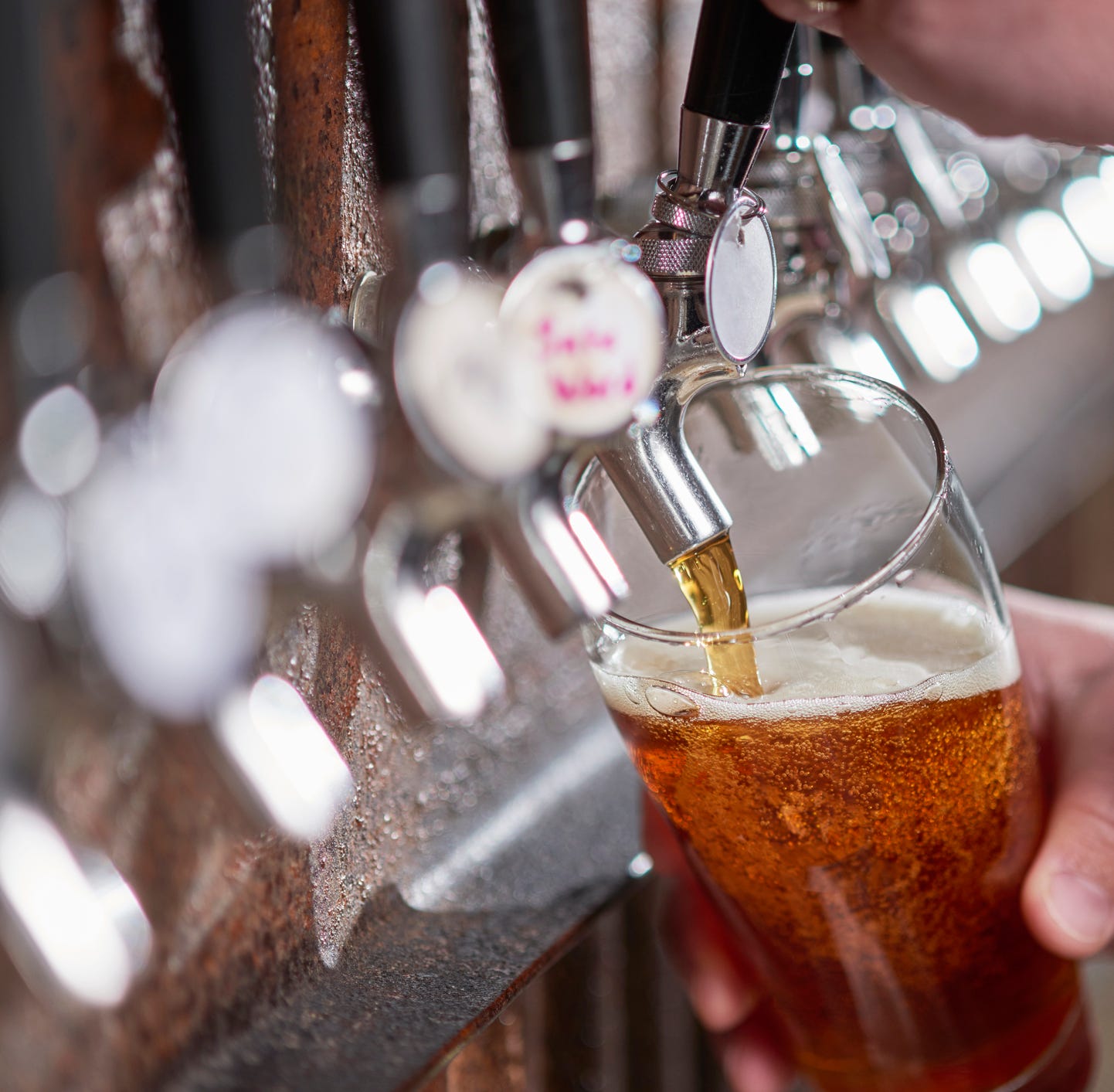 Craft beer being poured.