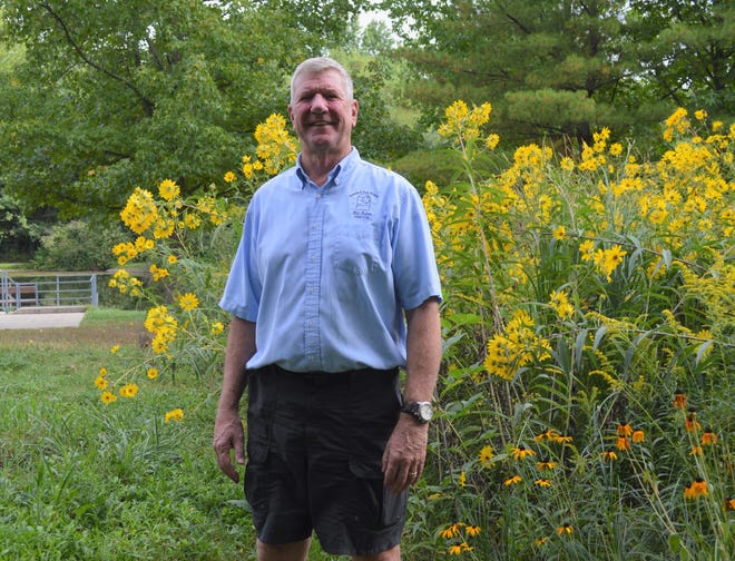 Bill Fisher stands in front of the butterfly garden at Lowe-Volk Park in Leesville on Friday morning.
