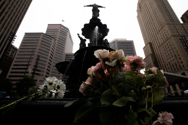 Flowers are laid on The Tyler Davidson fountain in Fountain Square on Friday, Sept. 7, 2018, in Downtown Cincinnati.  The square is was opened Friday morning after a gunman opened fire leaving four dead, including the shooter, and two injured. 
