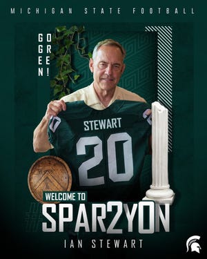 Mark Dantonio holds up an Ian Stewart jersey for a graphic that was sent to the class of 2020 prospect.