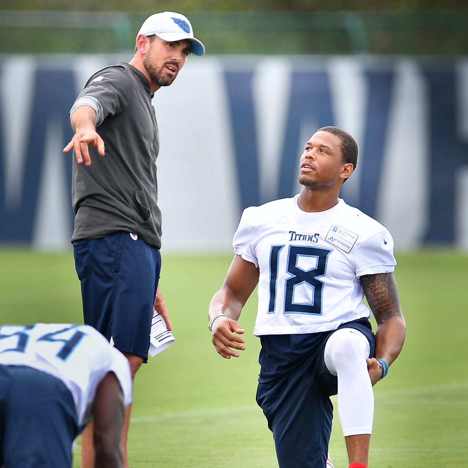 Tennessee Titans wide receiver Rishard Matthews (18) talks with offensive coordinator Matt LaFleur as he warms up before practice at Saint Thomas Sports Park Friday, Sept. 7, 2018, in Nashville, Tenn.
